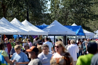 A crowd of people shopping at The Gardens GreenMarket